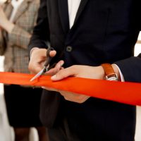 front-view-cutting-red-ribbon-grand-opening-building_8353-10570